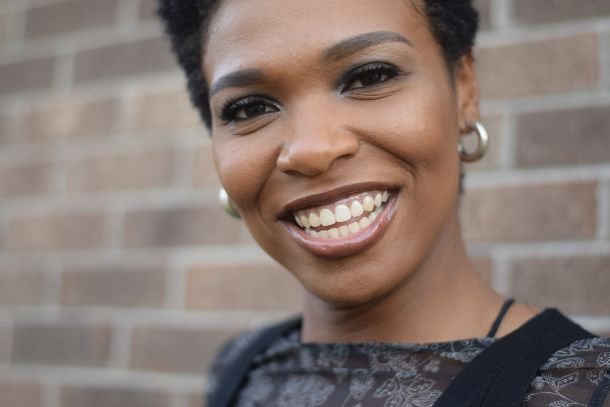 A woman smiles at the camera